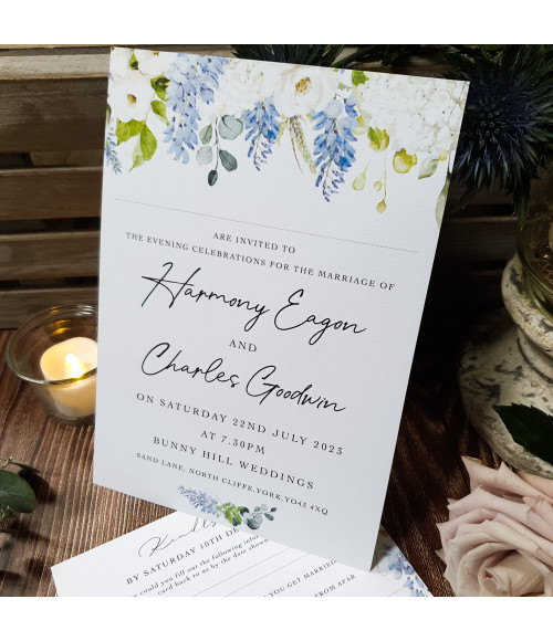 Luxury dusty blue evening wedding invitation featuring soft floral design and green foliage