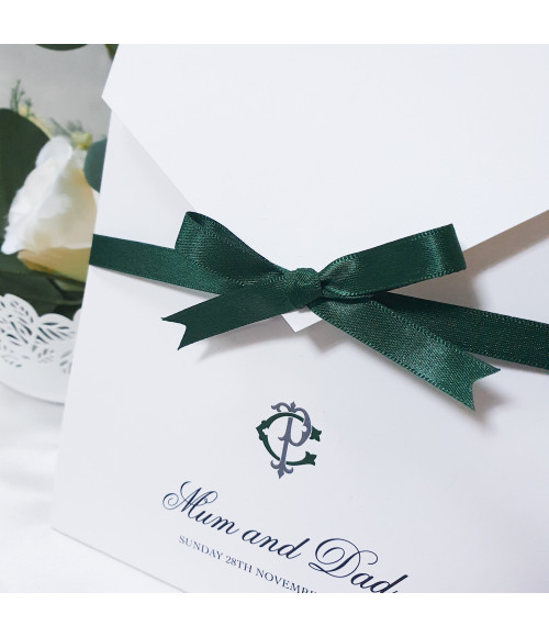 Personalised forest green wedding invitation with elegant monogram initials on luxury pearl card
