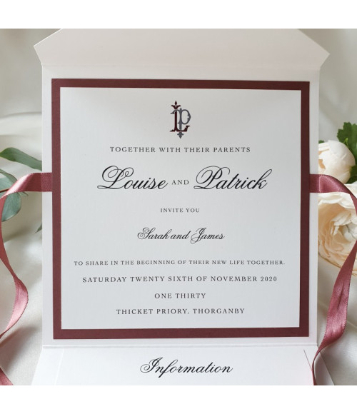 Romantic dusty rose wedding invitation with luxury satin ribbon bow.