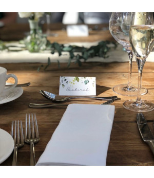 White floral folded wedding place name card printed on luxury textured card with the guest’s name personalised on the front.