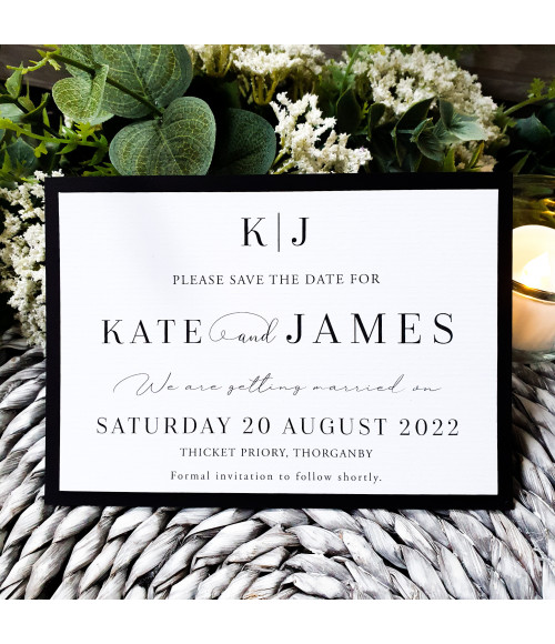 Modern black and white wedding save the date with personalised monogram