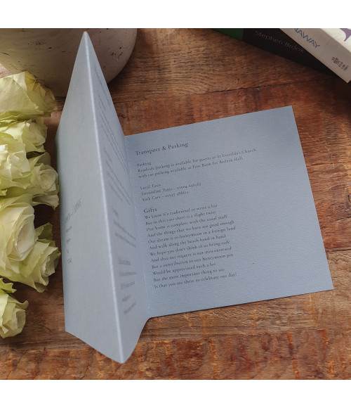 Dusty blue wedding invitations paired with elegant typography and premium finishes