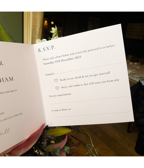 Romantic pink wedding invitation with delicate floral details, ideal for classic and modern wedding themes.