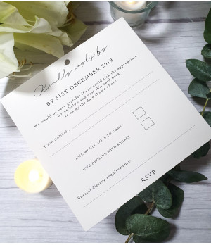 Wedding invite with ivory card and old rose pink ribbon, featuring an RSVP postcard and detailed information card