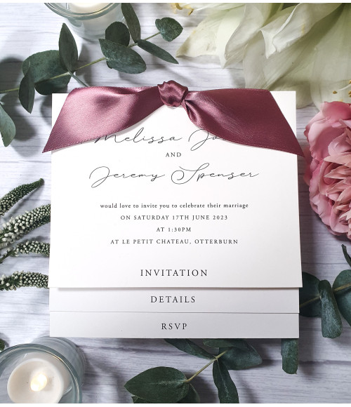 A delicate touch of elegance: Ivory wedding invitation with old rose pink satin ribbon