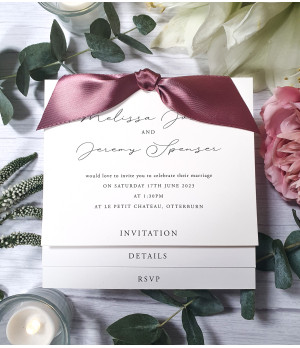 A delicate touch of elegance: Ivory wedding invitation with old rose pink satin ribbon