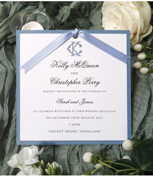 Luxury dusty blue evening wedding invitation with satin ribbon and personalised monogram design