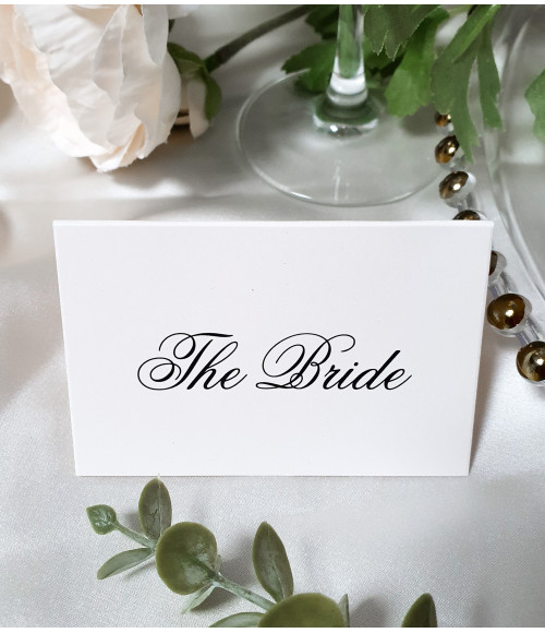 Luxury folded place name cards in a soft dusky pink shade, designed to complement romantic wedding décor.