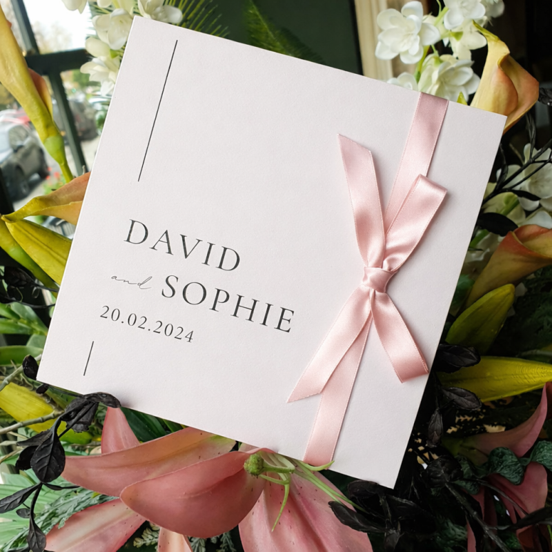Personalised pink day wedding invitation featuring an elegant floral design and luxury wedding stationery finish.