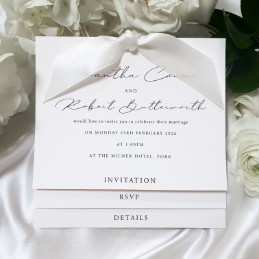 Elegant ivory wedding invitation with cream satin ribbon and luxury pearl card
