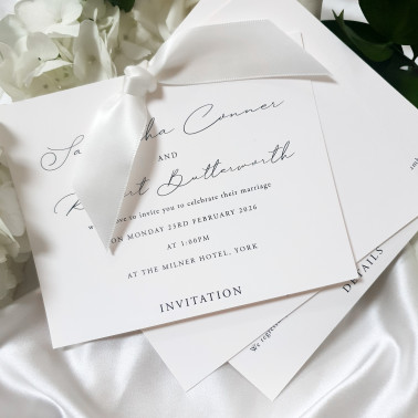 Luxury ivory wedding stationery with elegant script typography