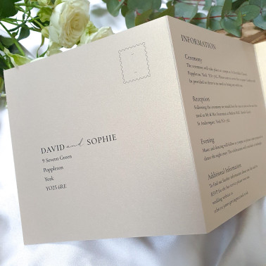 Luxury ribbon wedding invitation combining warm champagne card, cream details and modern typography.
