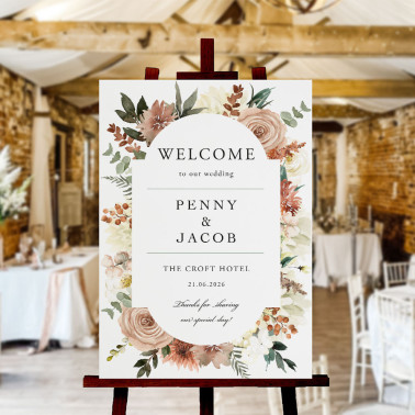 Personalised A1 wedding welcome sign with autumn floral design displayed on a gold easel at a stylish rustic wedding venue.