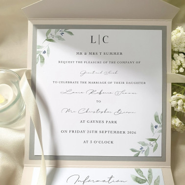 Close-up of the personalised wedding invitation inside the ivory pocketfold with sage botanical artwork.