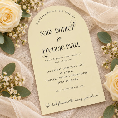 Personalised arched wedding invitation in soft pastel yellow with romantic floral details