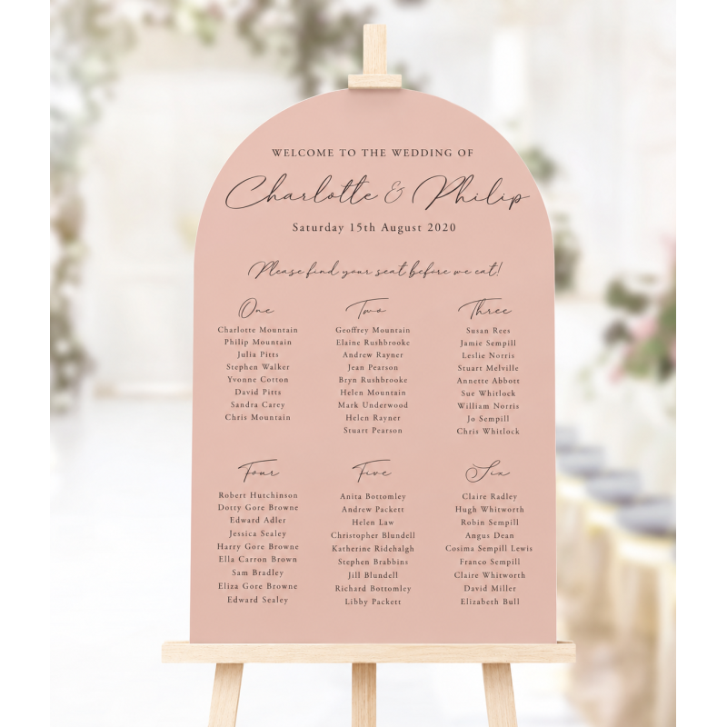 Arched blush pink wedding seating plan with elegant personalised lettering, a smooth curved top and classic table layout