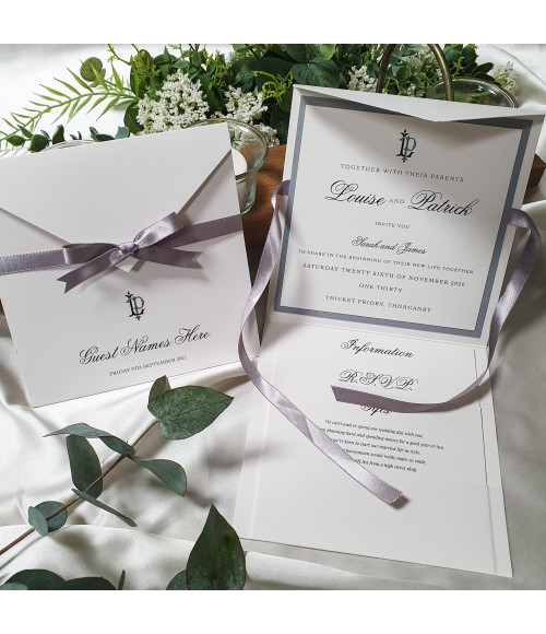 Luxury silver wedding invitation suite featuring elegant monogram design and premium pearl card finish