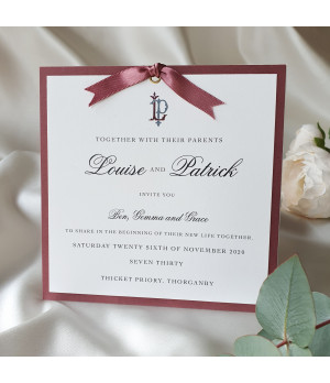 Luxury dusky pink evening wedding invitation with personalised monogram and satin ribbon.
