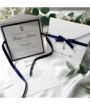 Luxury navy blue wedding invitation with personalised monogram and satin ribbon detail