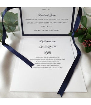 Elegant personalised wedding invitation with navy satin ribbon bow and pearl white card detail