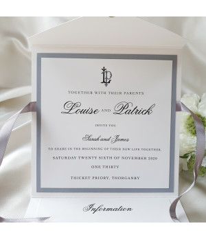 Premium pearl white wedding invitation featuring silver detailing and personalised guest name design