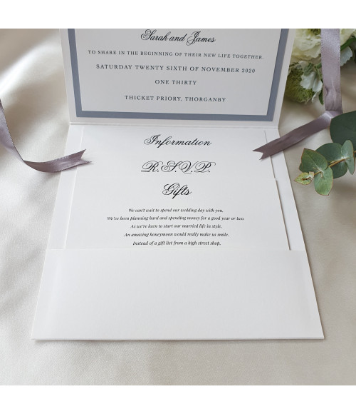 Elegant silver wedding invitation suite with monogram initials and minimalist luxury presentation style