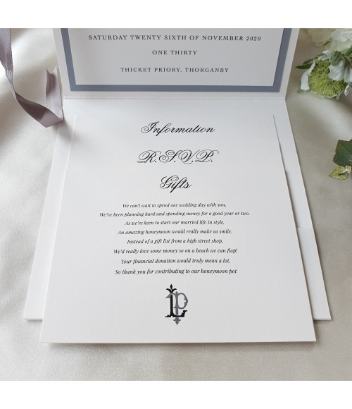Close-up of luxury silver wedding invitation with pearl card texture and refined personalised print