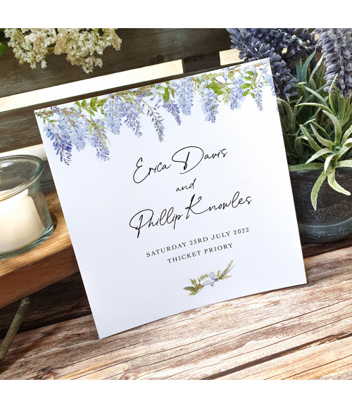 Blue, purple Wisteria wedding invite with white ribbon, floral design and textured card