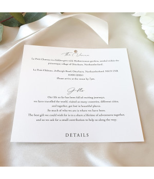 Close-up of ivory satin ribbon on luxury wedding invitation card