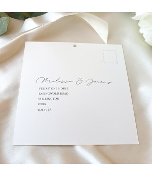 Luxury wedding invitation details with soft ivory tones and fine print