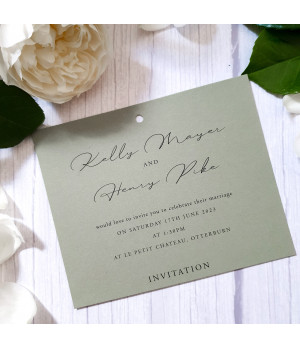 Close-up of sage green satin ribbon on luxury wedding invitation card